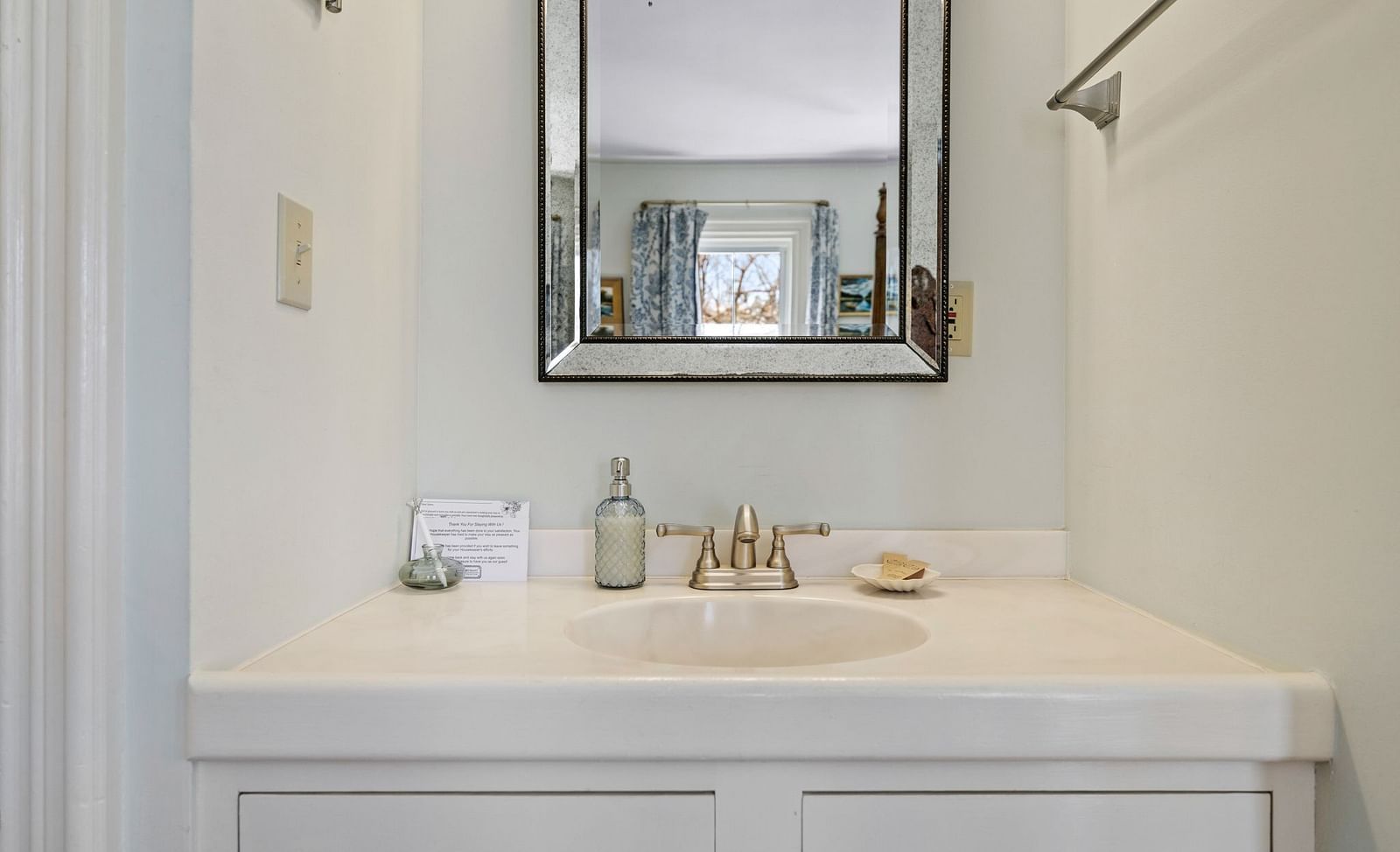 Bathroom vanity with mirror and toiletries at Hartstone Inn