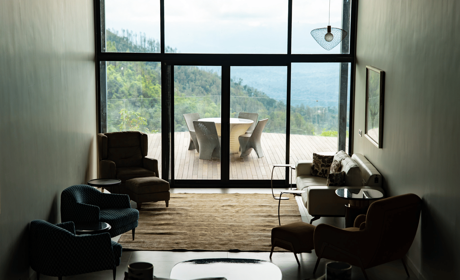 A spacious living room at Stanley Revelation with floor-to-ceiling windows and a view of the mountains.