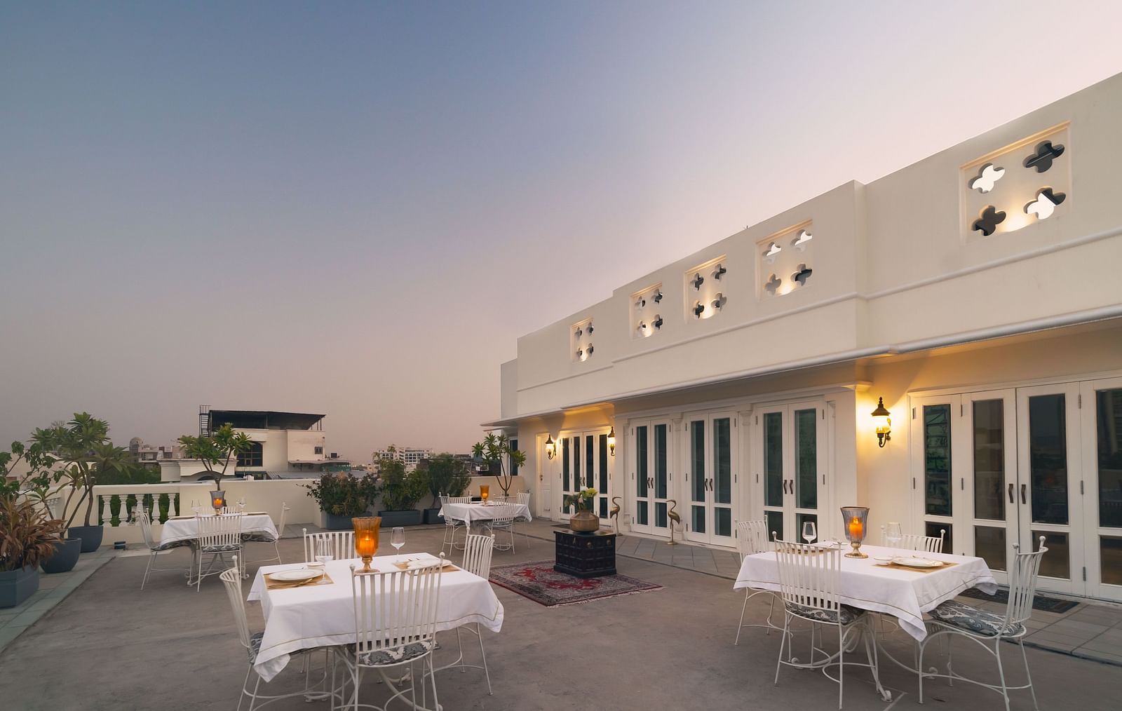 An open-air rooftop dining arrangement at Dileep Kothi, Jaipur