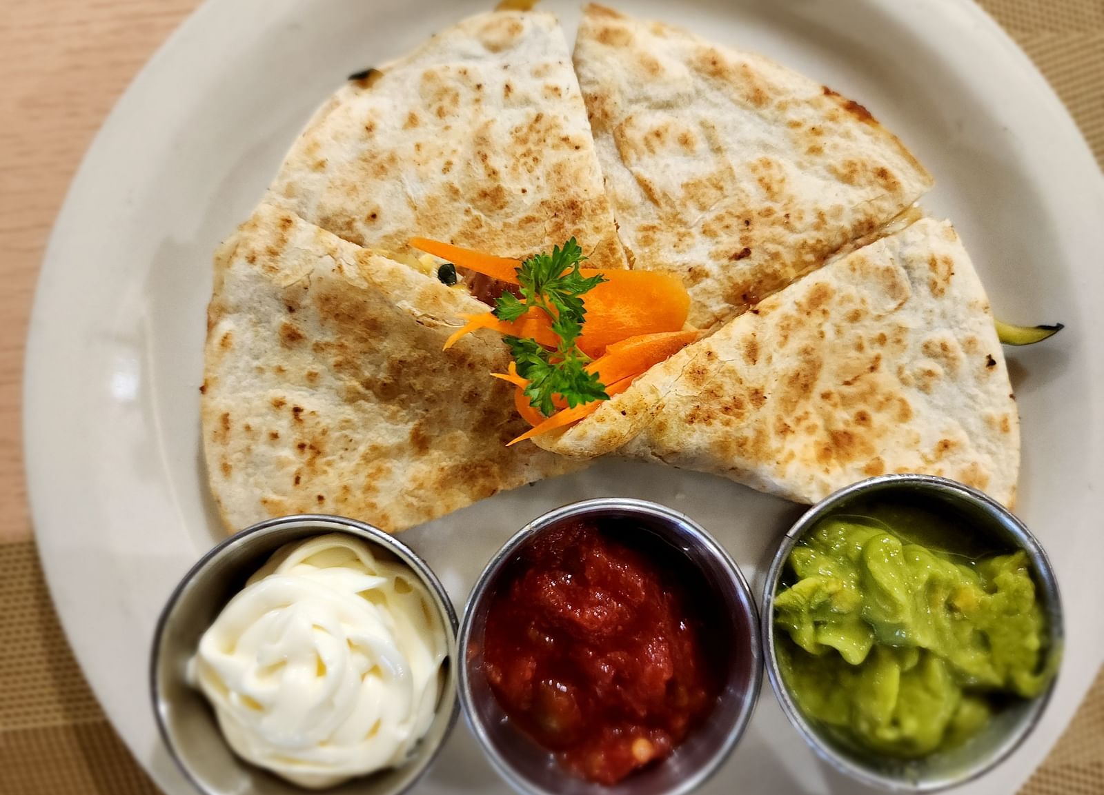 Close-up of quesadilla with salsa, sour cream, and guacamole trio - Hotel 39, Jamaica