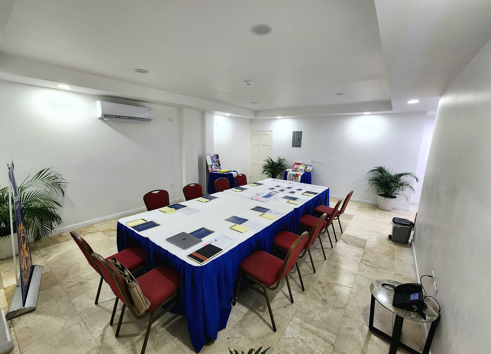 A clean, modern meeting space in Montego Bay with red chairs and a white conference table - Hotel 39, Jamaica (Montego Bay)