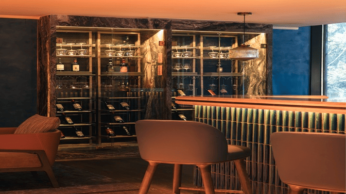 Stylish bar interior with warm lighting and seating at The Residency Towers Chennai.