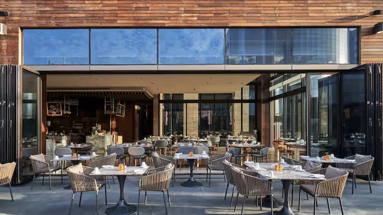 Outdoor seating area at The creek – The Den restaurant