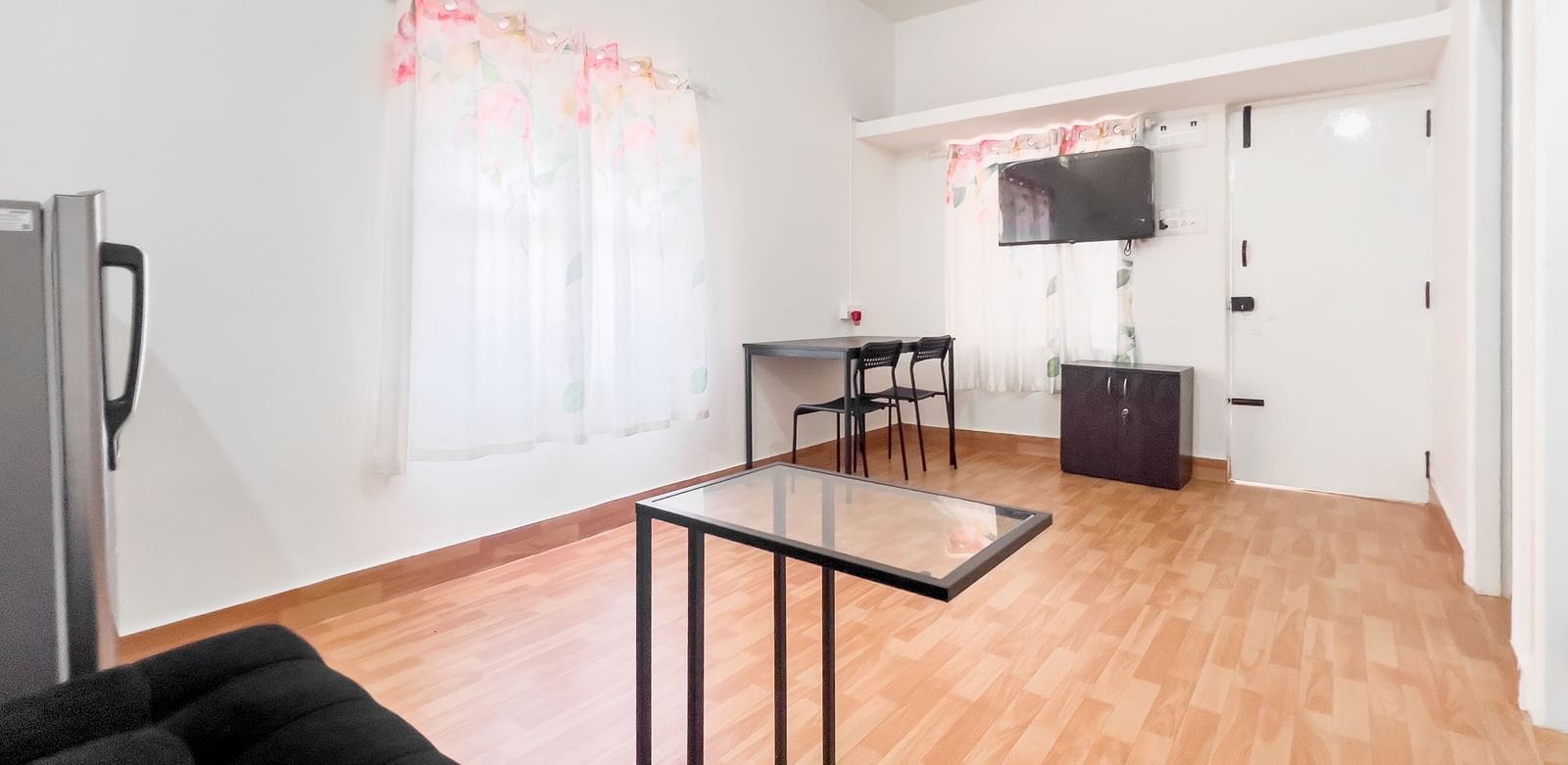 Open-plan living area with sofa, dining table, and kitchen at The Pinnacle, Electronic City.