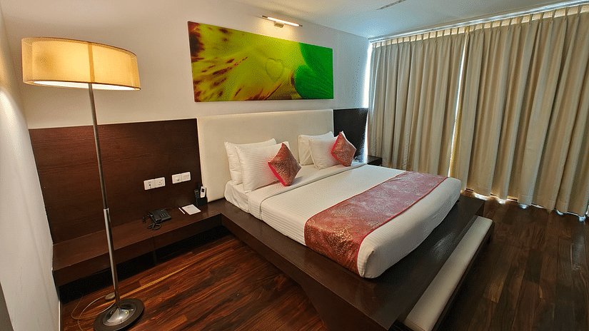 Side view of Suite Room with a luxurious king sized bed and a bedside lamp beside it at Springs Hotel & Spa