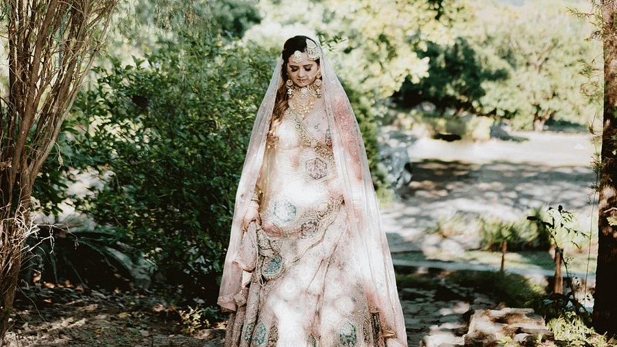 A photo shoot of a bride surrounded by trees at The Sylvan Retreat, Dehradun.