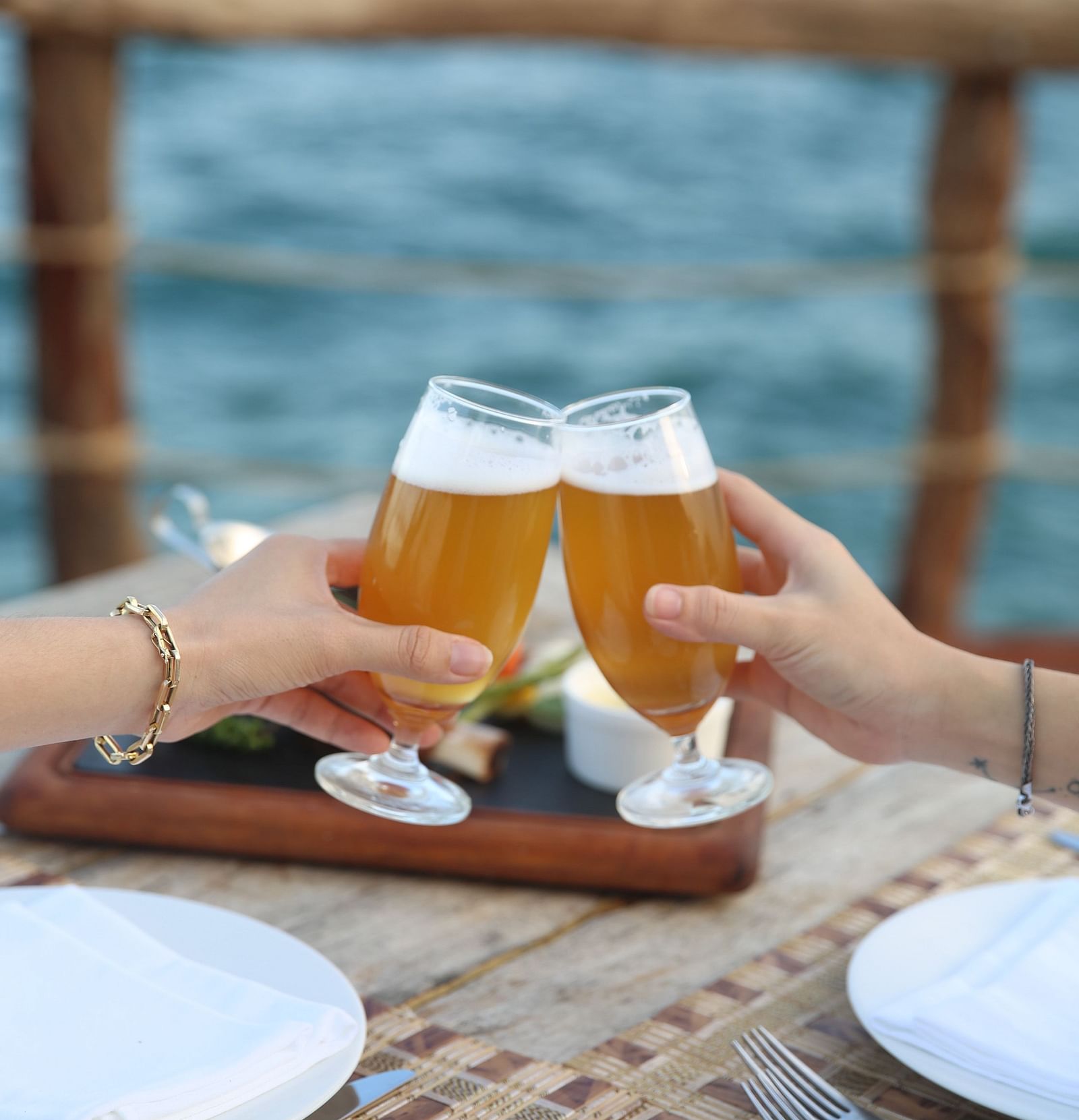 Two people clinging their beer glass - Alibu Resort Nha Thrang
