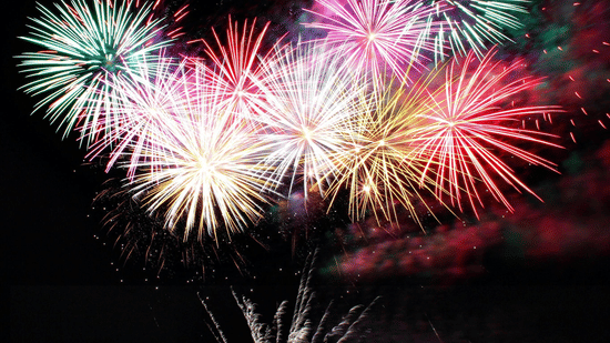 Fireworks lighting up the night sky over a festive gathering