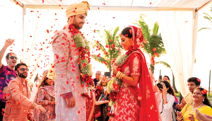 a bride and groom standing during a ceremony - Caravela Beach Resort Goa