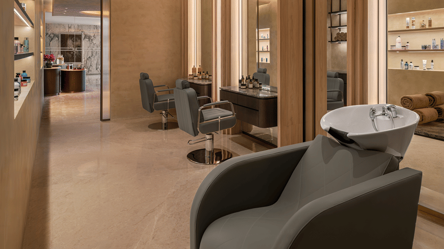 Salon area with styling chairs, mirrors and a wash basin station at The Residency Signature Madurai.