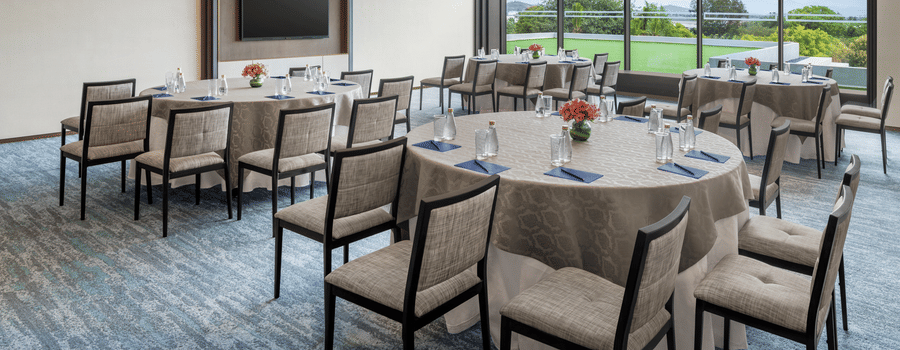 Town Hall set up with round tables for a dining or conference event at The Residency Signature Madurai.