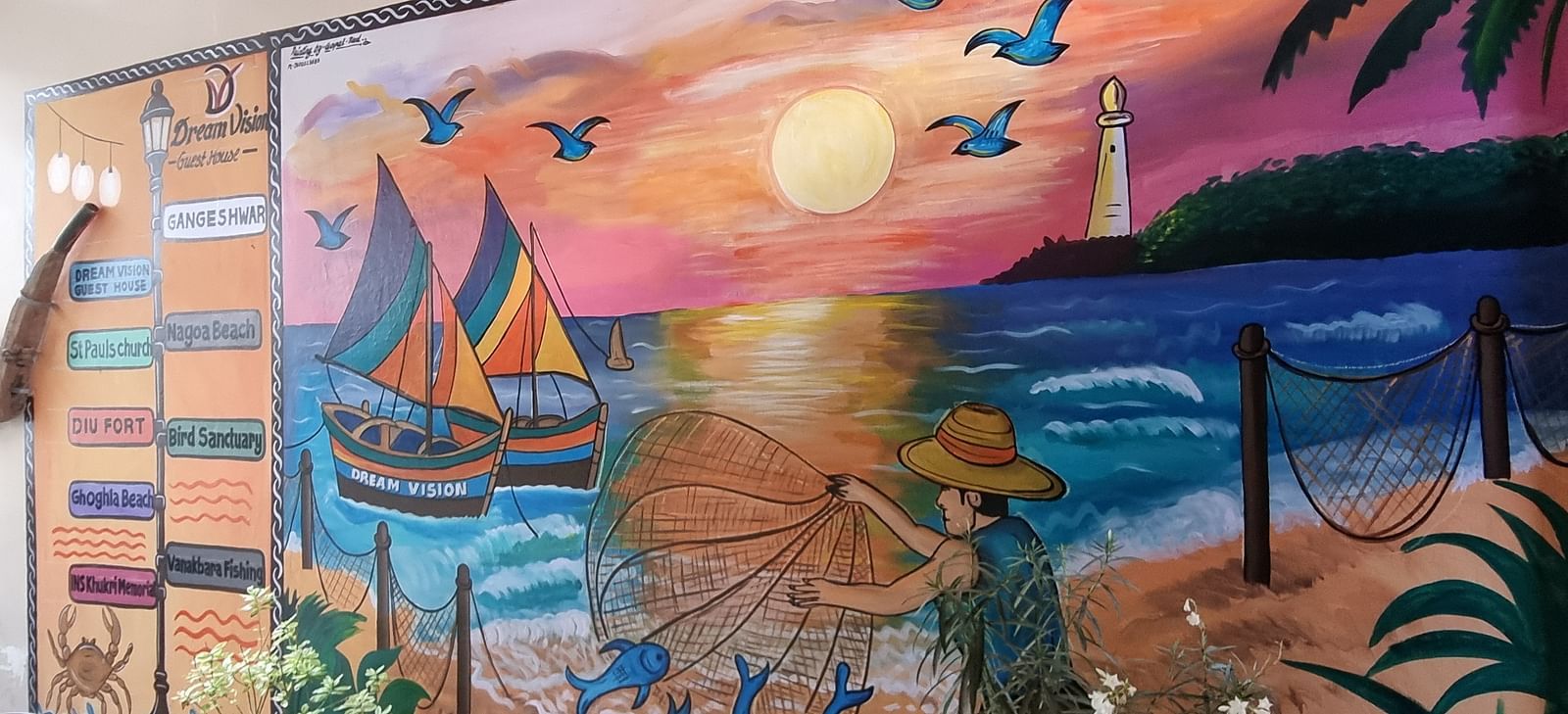 A beautiful wall mural depicting a fisherman spreading his net in the ocean at Dream Vision Guest House.