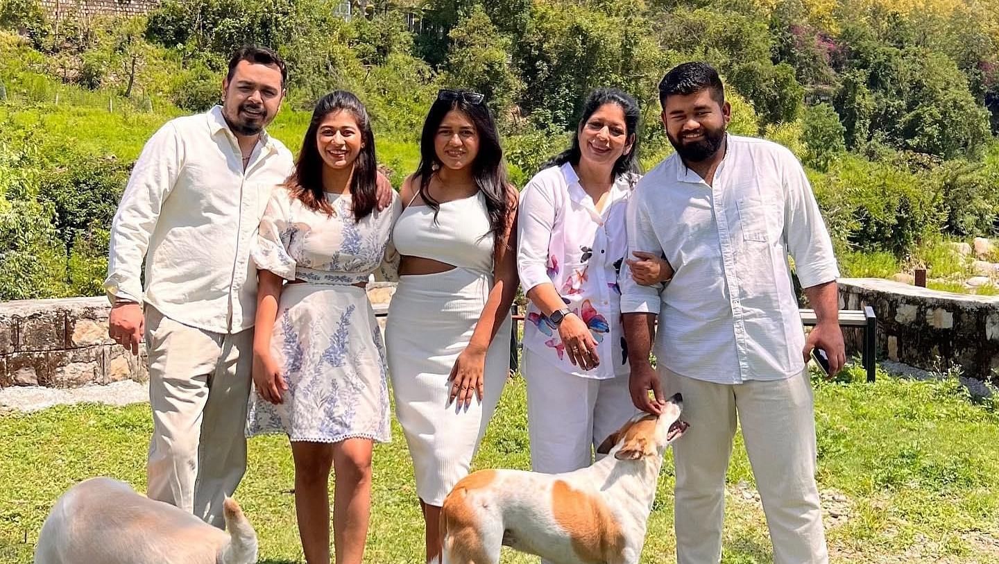 A family picture in a lawn on a sunny day at The Sylvan Retreat, Dehradun.