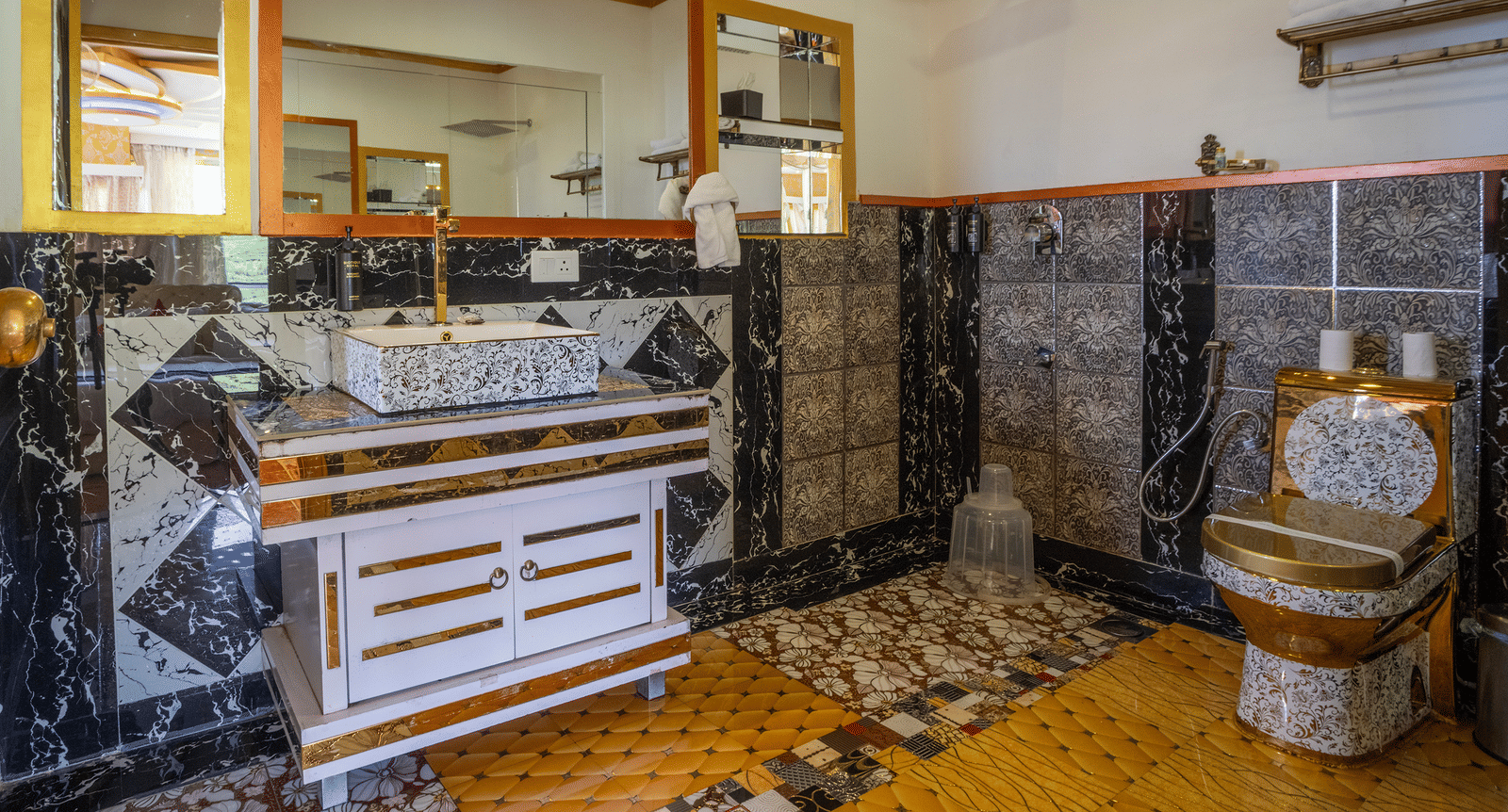 The bathroom in the Jacuzzi 180-degree Suite at Parakkat Nature Hotel and Resorts, Munnar, featuring highly textured wall paneling, a large mirror, and distinctive floor patterns.
