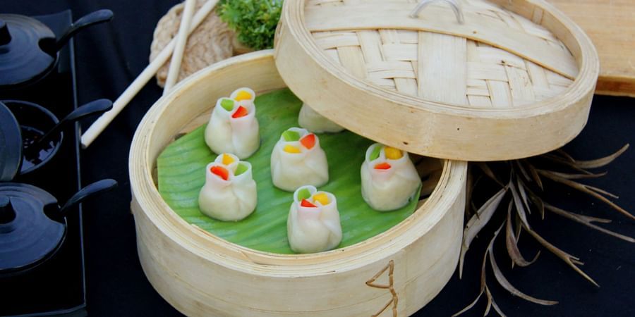 Dumplings served in a bamboo steamer.
