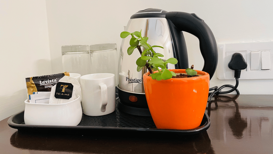 In-room tea and coffee setup with electric kettle at Sanctum Suites Domlur Bangalore