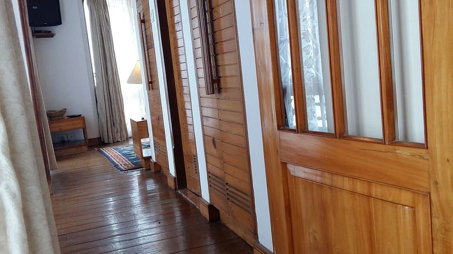 The walkway in Cedar Inn in Darjeeling leading to a door opening.