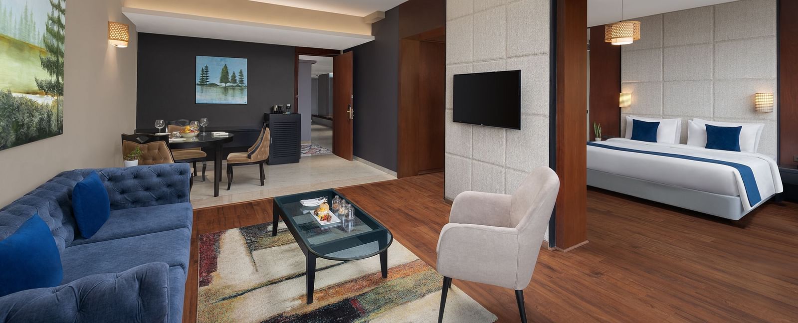 Living room area of Execuitve Suite at Essentia Luxury Hotel, Indore with sofa seating and coffee table set up.