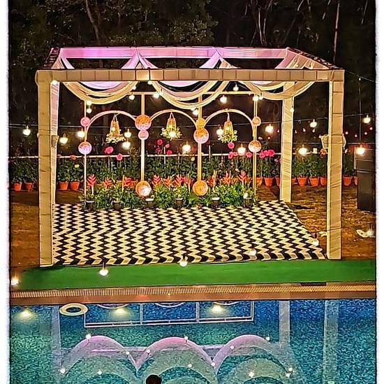 A decorated wedding mandap with lights.