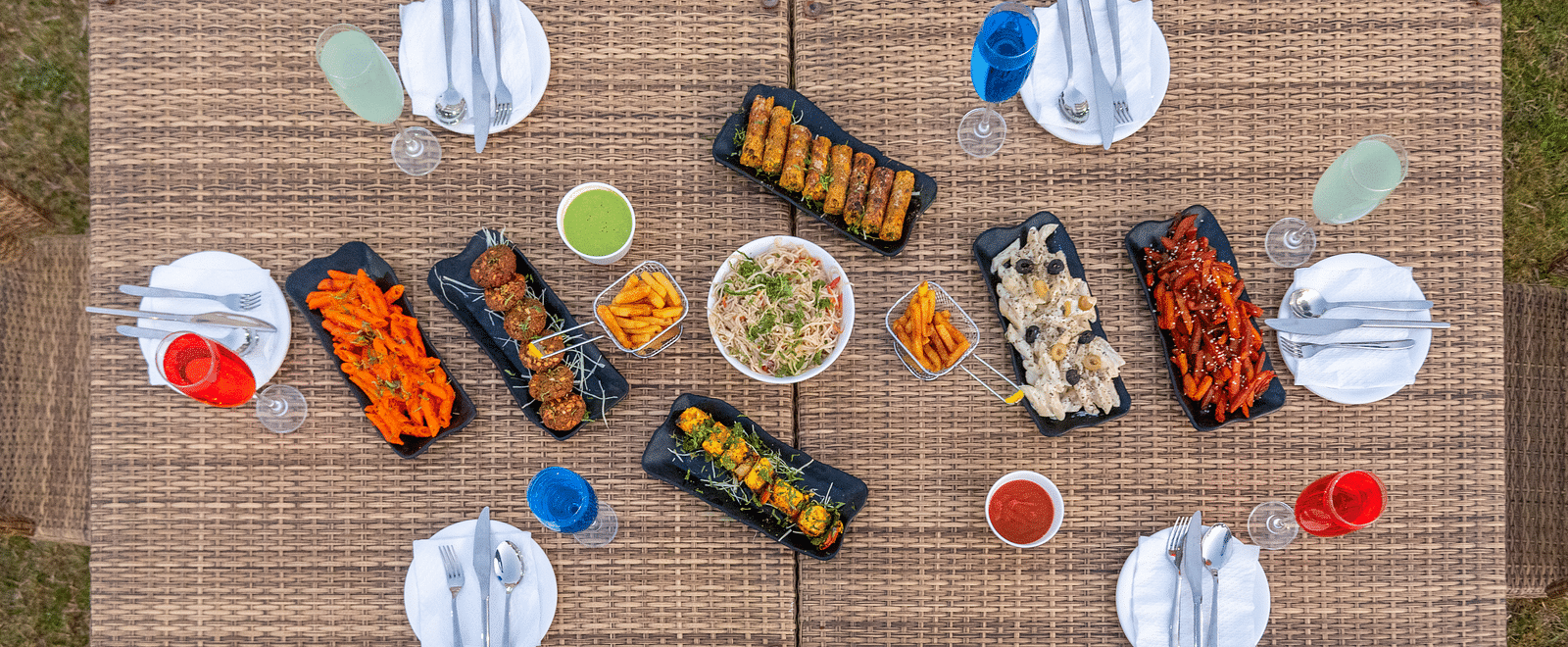 Outdoor dining setup with neatly arranged food and cutlery at DLS Park Grace, Haridwar.