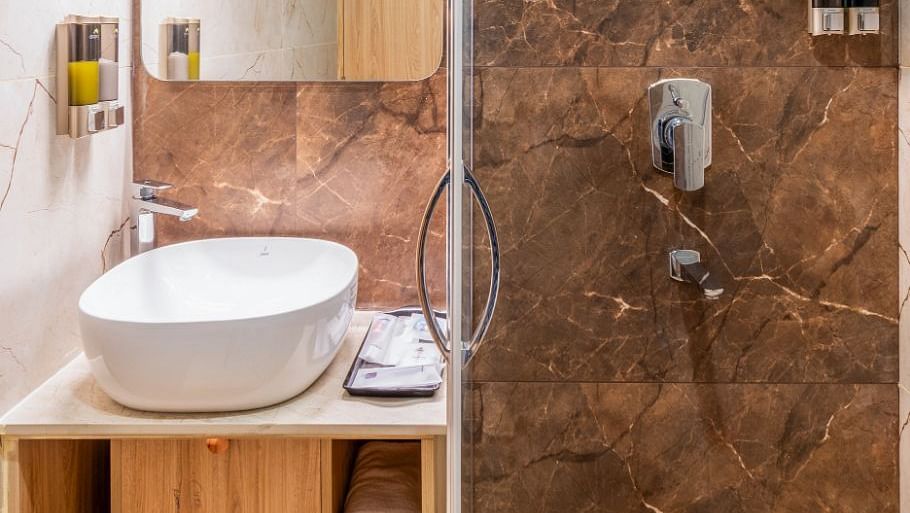 Shower area with modern fittings in The Premium Rooms at TGI Livancia The Sojourn, Bangalore.