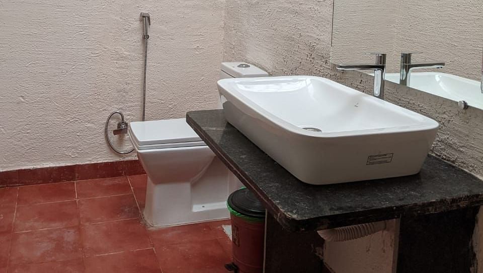 A washroom with a sink and a toilet at The Conservancy Bungalow.