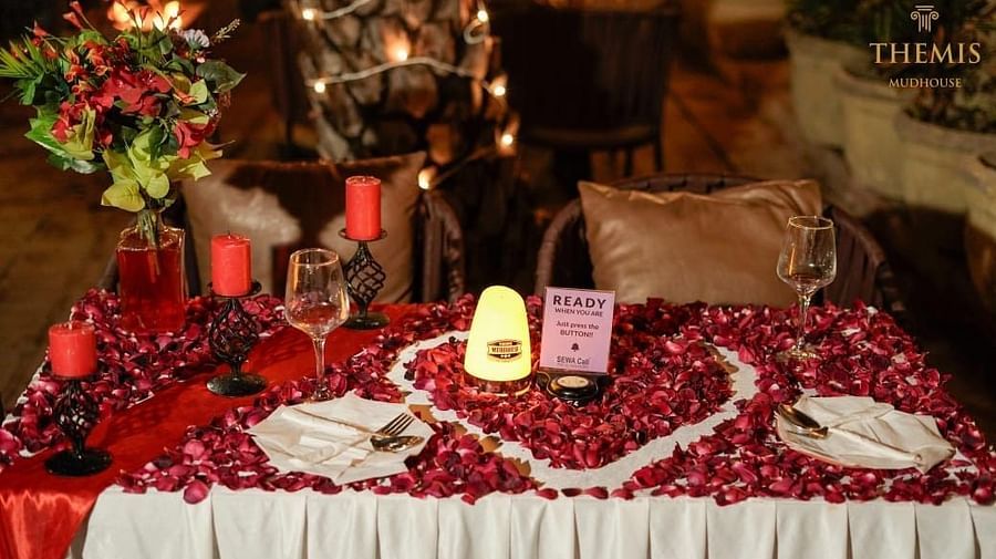 Candle light dinner with a rose petal decoration at themis mudhouse.