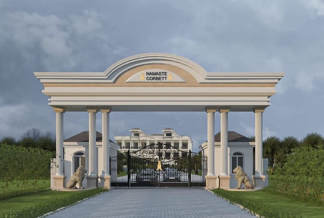 The entry gate to Namaste Corbett, flanked by greenery.