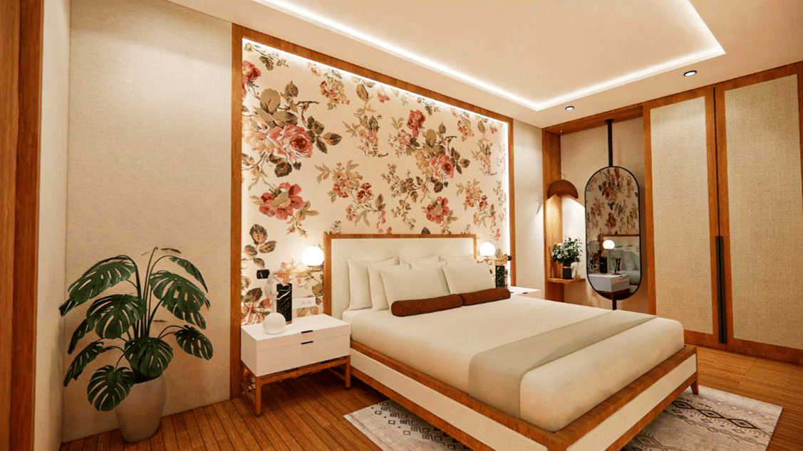 A premium double bedroom at Pride Elite Himmatnagar stands out with its beautiful floral accent wall design.