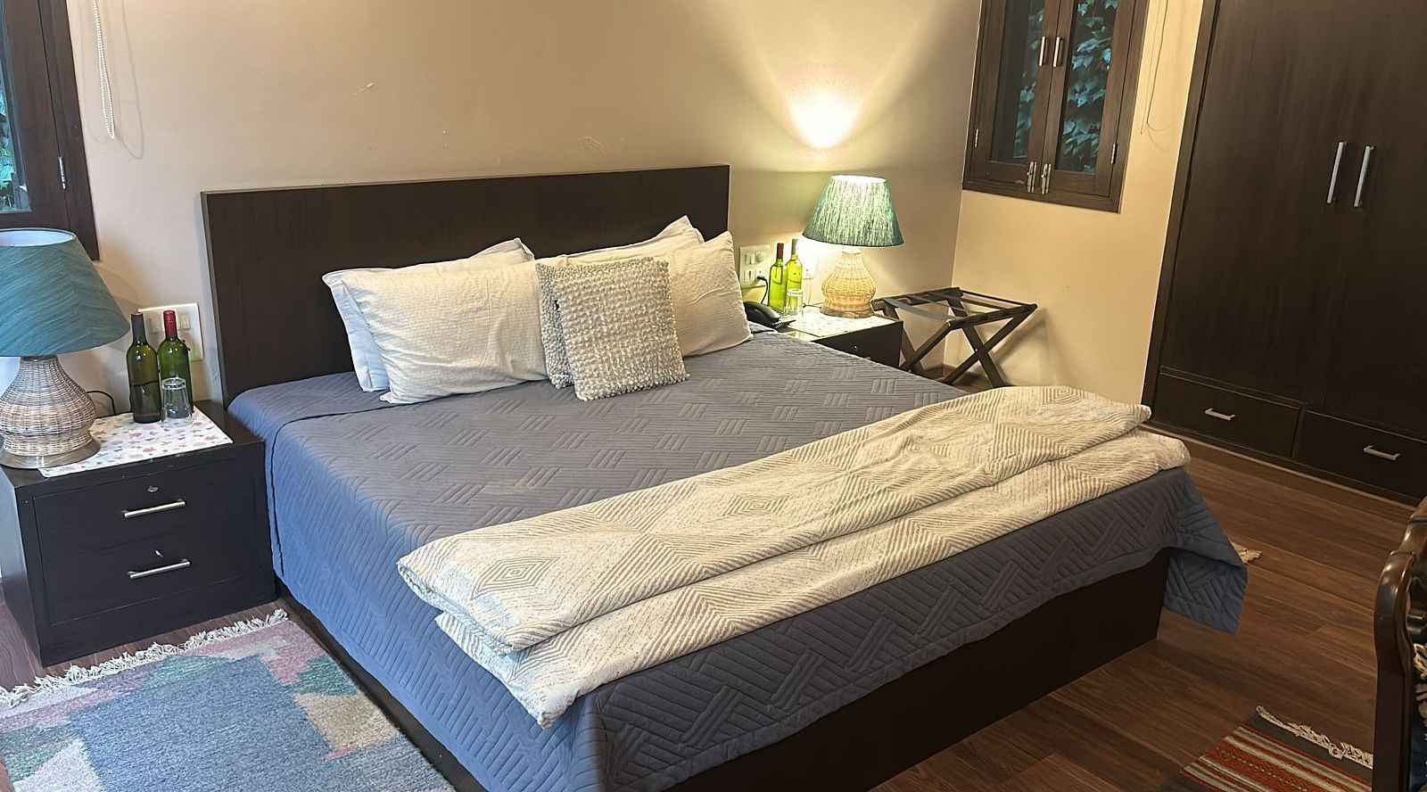 A large bed next to a nightstand in one of the bedrooms in 2BHK at SOUTHGATE KASAULI BY ZENQ.