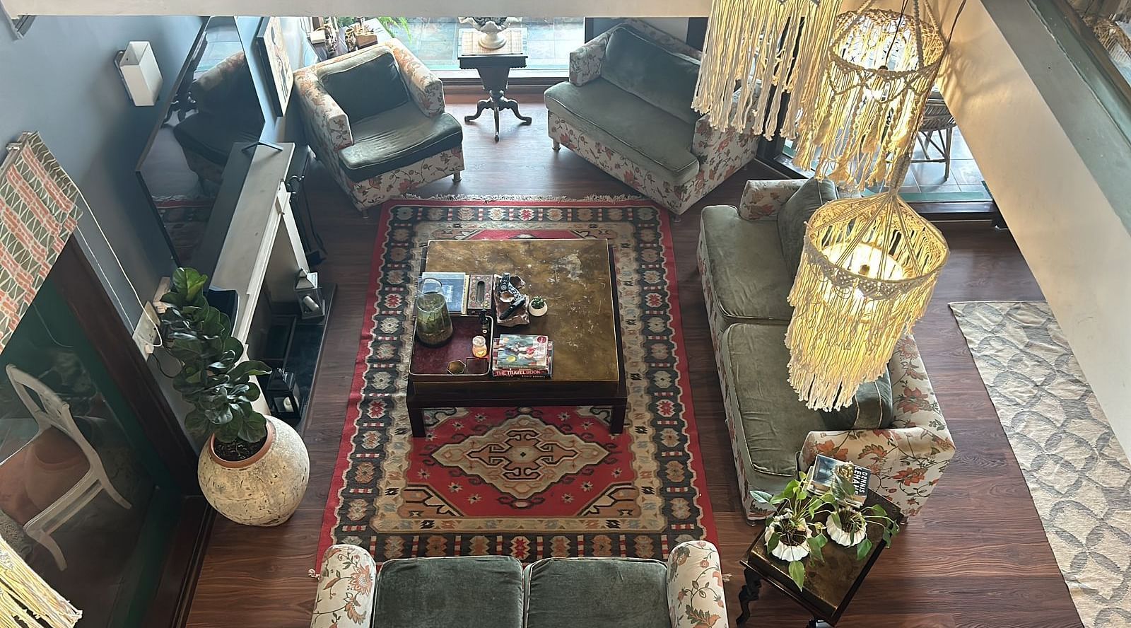 Aerial view of living area with comfortable sofas around a table at 2 BHK at at SOUTHGATE KASAULI BY ZENQ.