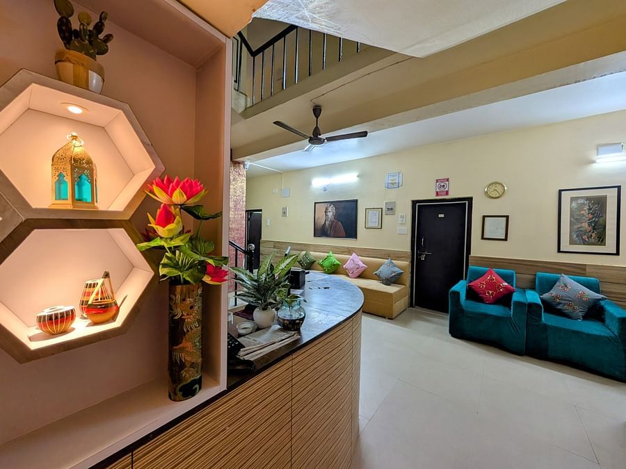 An image of a reception lobby featuring a showcases, seating areas, frames hanging on the wall and other decorative things - Rangamati Garden Resort