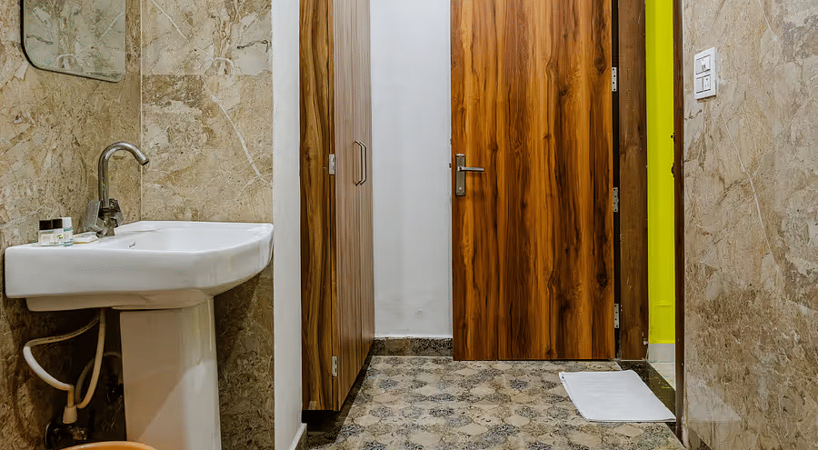 A bathroom with a pedestal sink, and a wall mirror - Lime Tree Hotels & Banquet, Vrindavan 