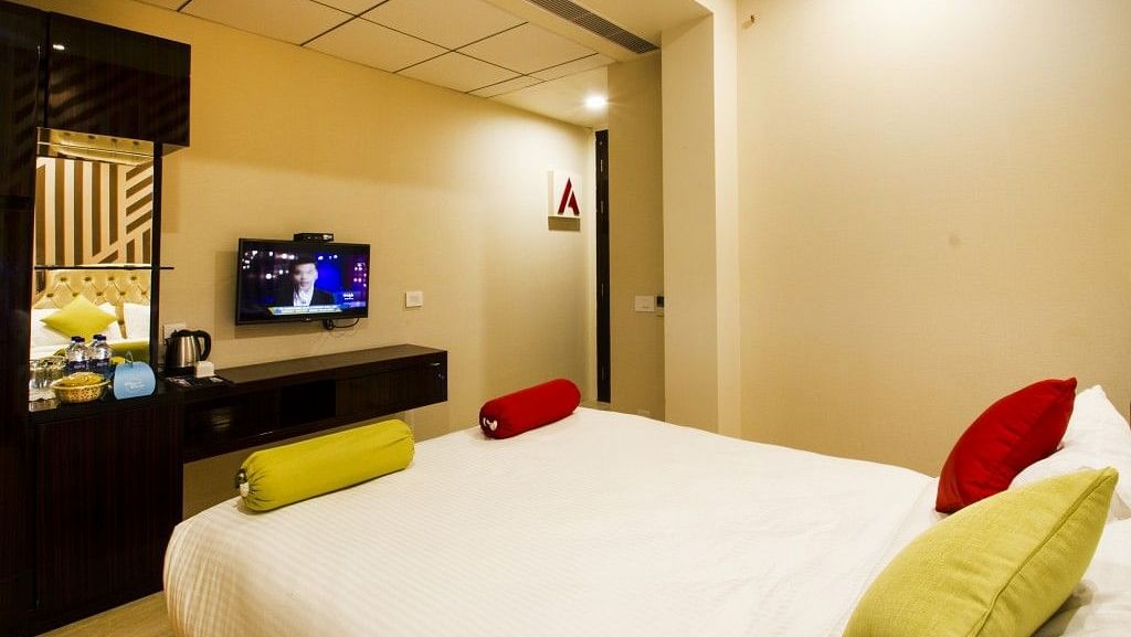 Standard room with bed and television on the wall at Art Boutique Hotel, Hyderabad