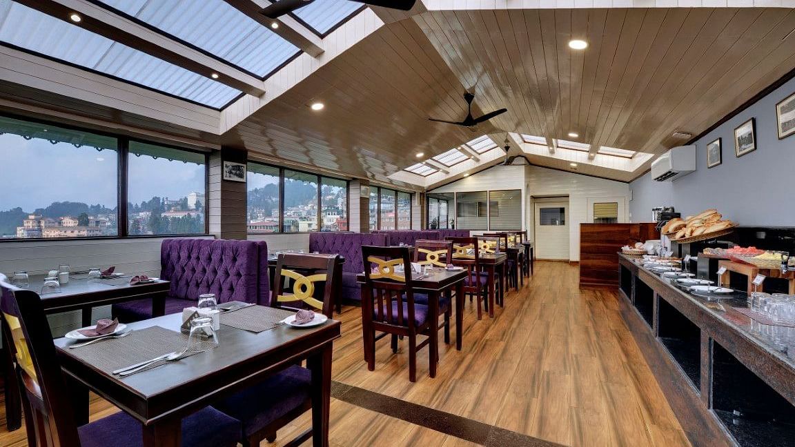 Restaurant Blue Charcoal's front view with seating arrangements and a buffet setting - Sumitel Boutique Resort, Darjeeling