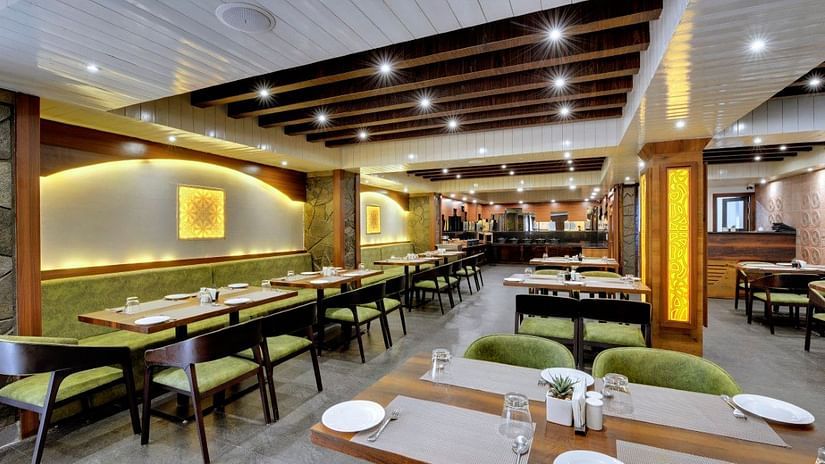 Restaurant Blue Charcoal with tables and chairs for seating and overhead lighting - Sumi Queensyard, Darjeeling