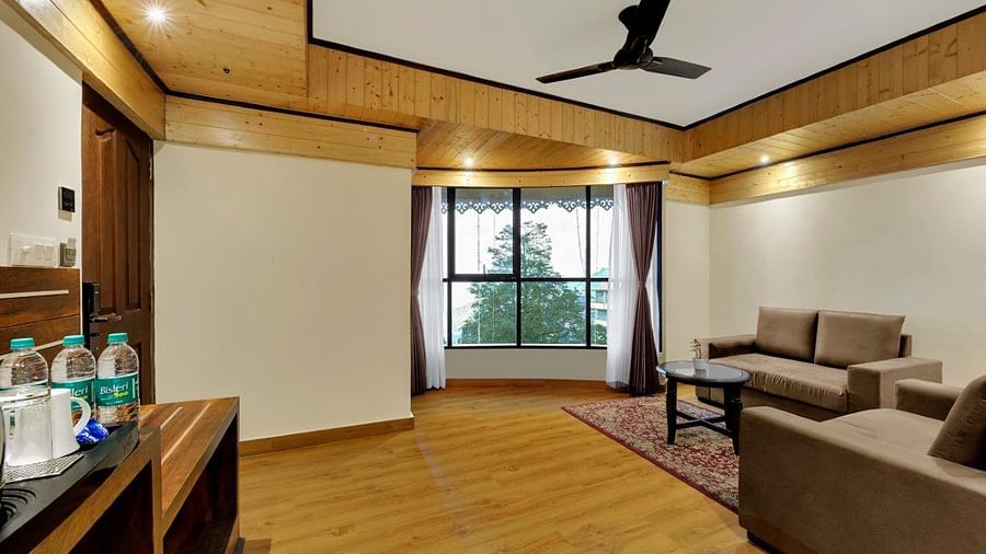 Premium Family room living area with sofas and large windows with outside views - Sumi Queensyard, Darjeeling