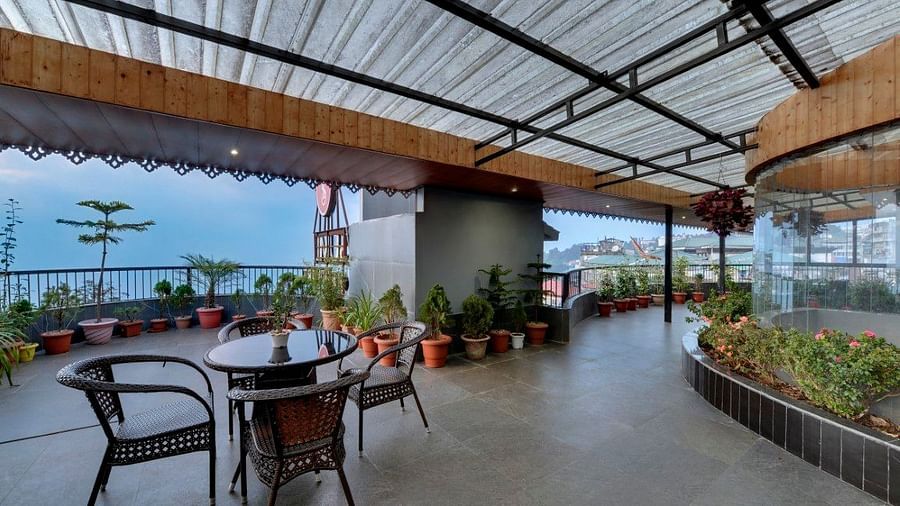 Terrace with Darjeeling views and tables and chairs for seating - Sumi Queensyard, Darjeeling