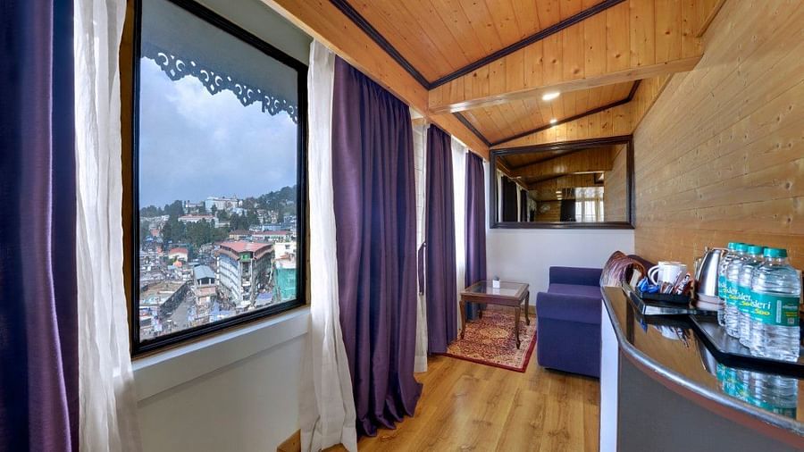 Premium Family room living area with purple curtains and a sofa - Sumitel Boutique Resort, Darjeeling