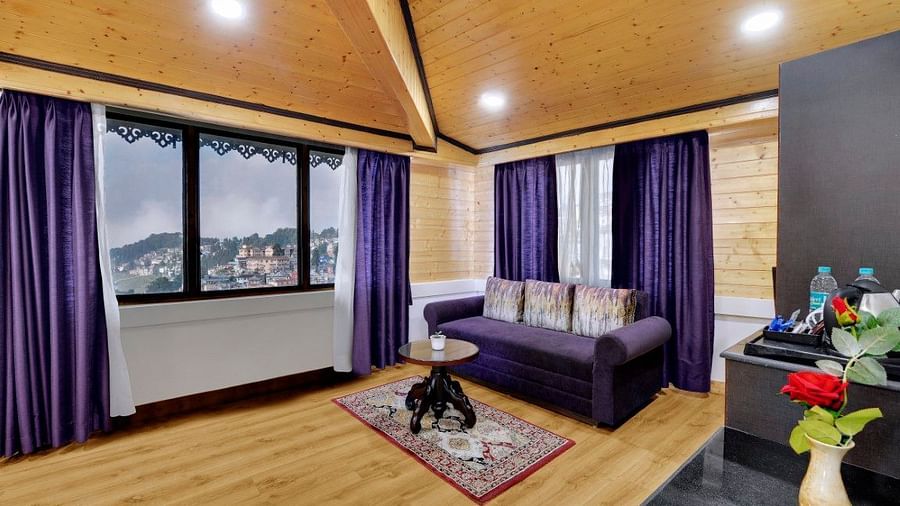 Premium Family room living area with purple curtains and a purple sofa - Sumitel Boutique Resort, Darjeeling