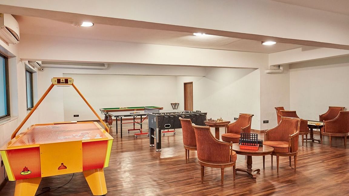 an image of the indoor game room with air hockey, pool and more - Rhythm Lonavala