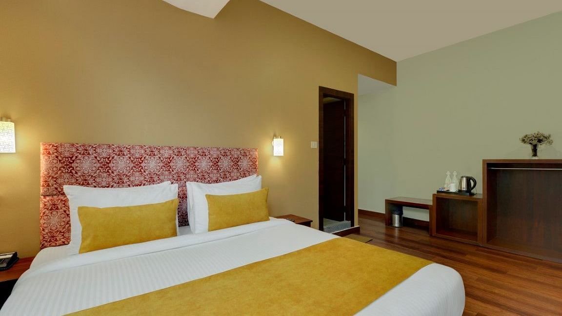 Shot of a king size bed in the deluxe room of our hotel | Yashshree Lachung
