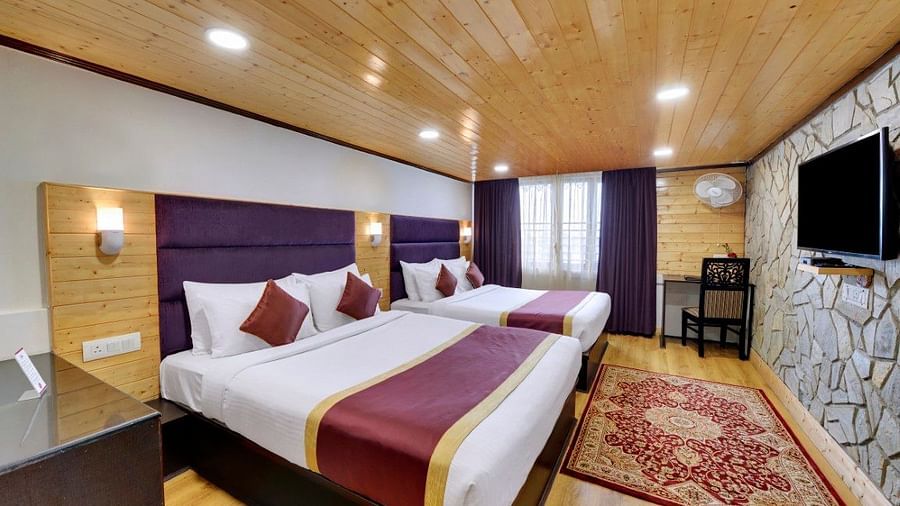 An image of a room with twin bed, flat screen TV, decorative lighting - Sumitel Darjeeling
