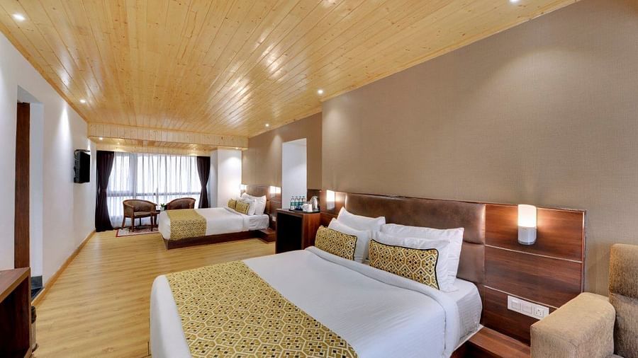 An image of a room with two queen size beds, TV, sofa, lamps and minimal decoration - Sumitel Vista TV Tower