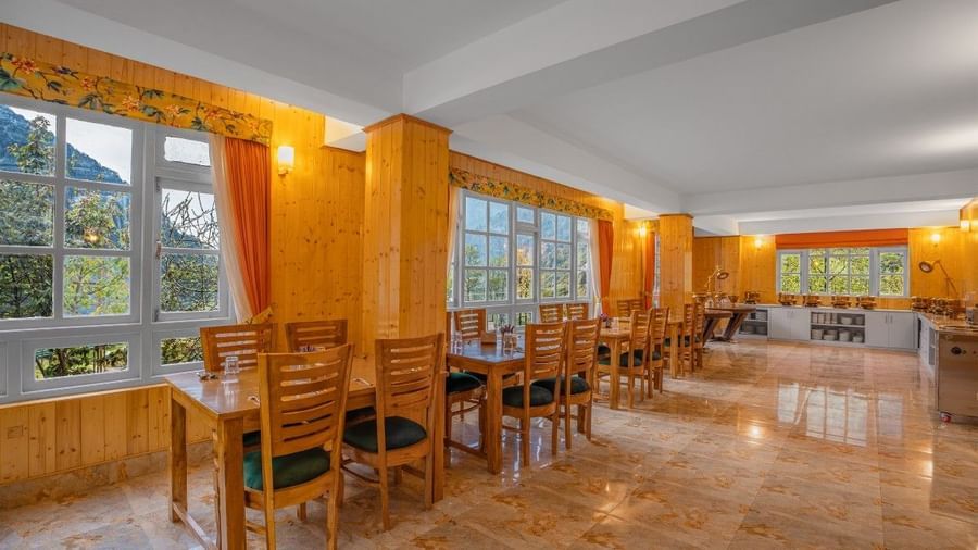 Image of a restaurant with sitting area and view of the mountain in front at Summit Gangchen Hotel, Lachen