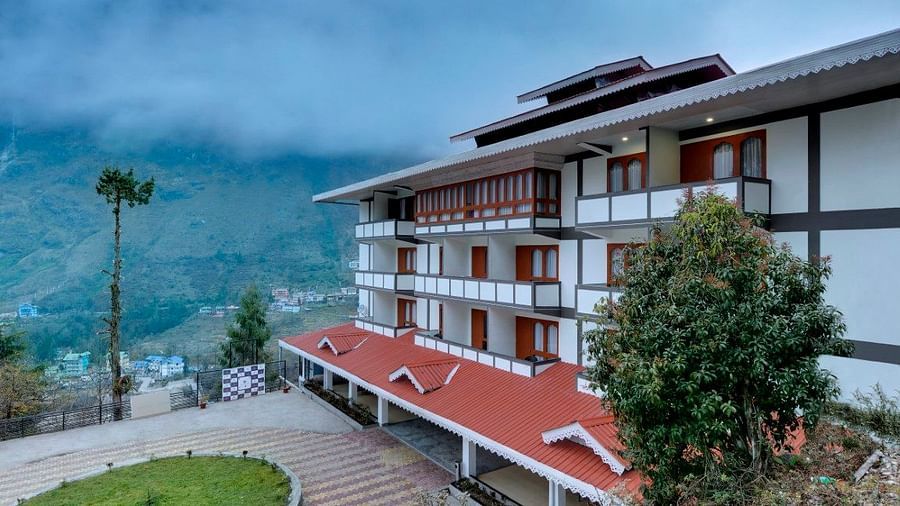 Shot of the hotel facade with clear sky and trees in the background |  Yashshree Lachung
