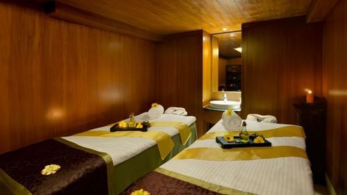 An overview of the massage tables inside the spa with towels and other things kept on it - Kenilworth resort & spa, goa