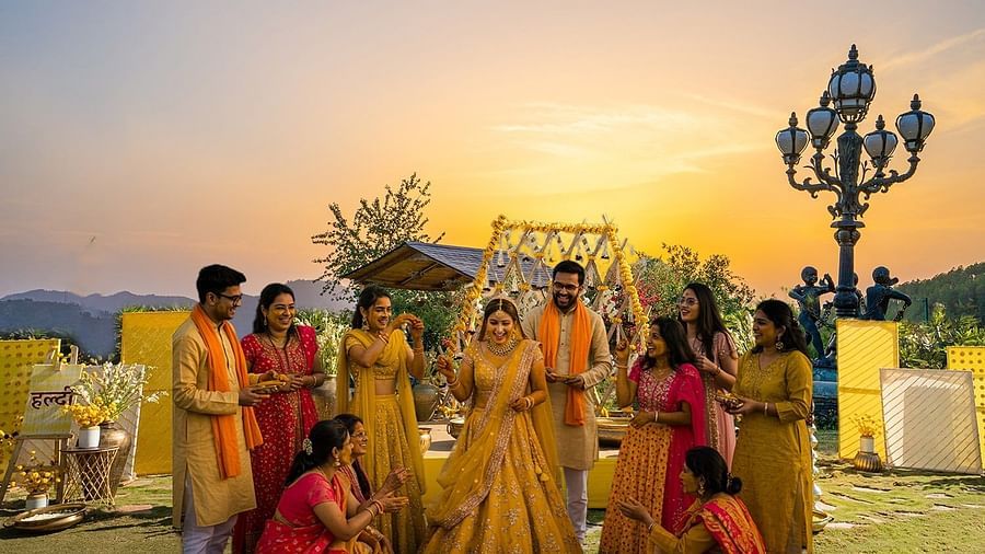 Haldi ceremony with vibrant yellow decor and mountain views, perfect for a traditional Indian wedding function.