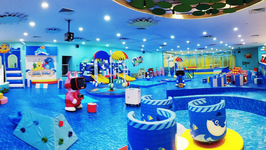 Soft play barrels with friendly sea creature graphics are arranged across the spacious floor at Tic Tac Tot.