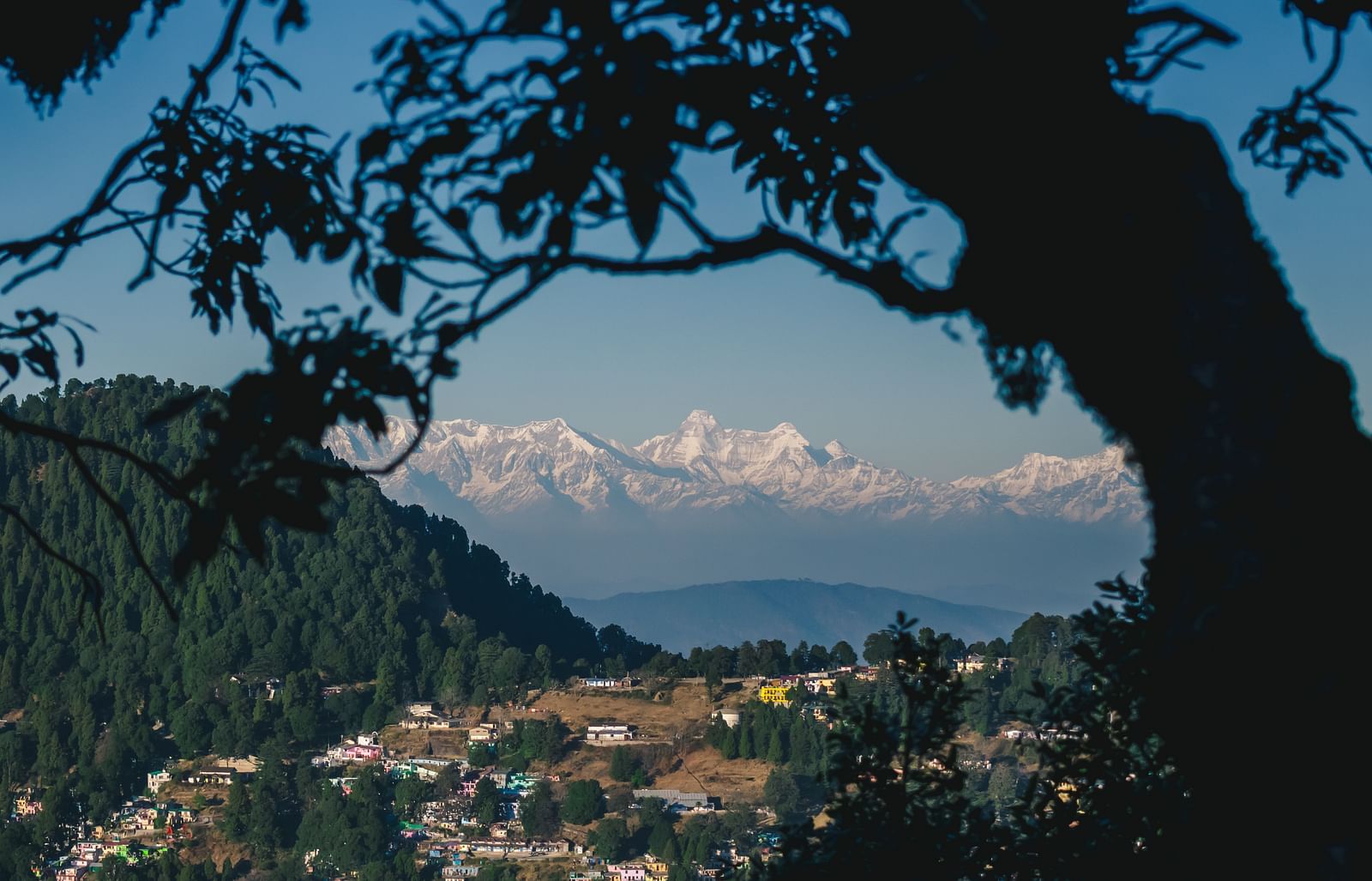 A top-angle shot from a mountain view, offering a panoramic view of the entire city below.